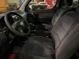 a car that is sitting in a room with a steering wheel