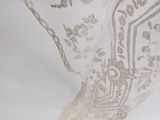 a close up of a white lace table cloth