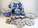 many pieces of blue and white pottery on the table