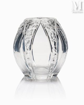a glass vase that is sitting on a white surface