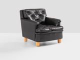 pair of black leather lounge chairs with wooden legs
