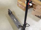 a scooter that is sitting on the floor in a room
