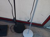 a floor lamp that is on the ground next to a laptop