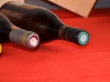 three bottles of wine sitting on a red table