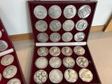 a lot of silver coins in a red case