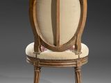 an image of a wooden chair with a beige upholstered seat
