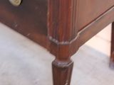 a wooden dresser with a drawer on top of it