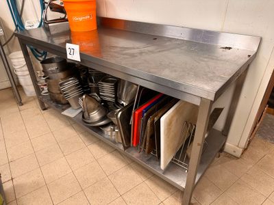 a stainless steel table with a bunch of pots and pans on it