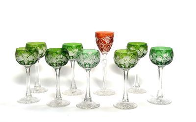 six wine glasses are lined up in a row on a white surface