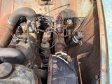 an old car with an engine in it ' s trunk
