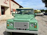 a green truck that is parked in front of a building