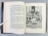 opened book with black and white photograph of a group of people sitting on steps