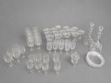 many glasses and a decanter sitting on a table