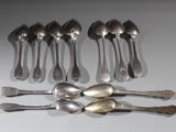 several spoons and forks are arranged in a row on a table