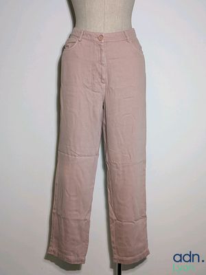 pink pants on a mannequin stand against a white wall