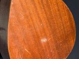 a close up of a wooden object on a black background