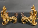 pair of antique gold leaf and scroll bookends on a black background