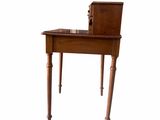a small wooden desk with a drawer on top of it