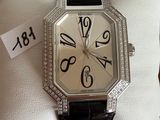 a watch that is sitting in a box on a pillow