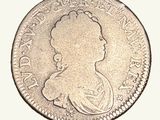 une vieille pièce d'argent sur laquelle figure le profil d'une femme