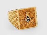 a close up of a gold ring with a masonic symbol on it