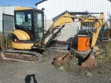 a small excavator that is sitting in the dirt