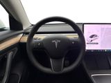 steering wheel and dashboard of a car with a laptop on the dashboard