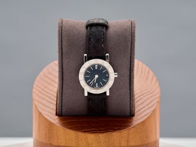 a watch sitting on top of a wooden stand