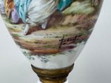 a vase with a picture of a man and a woman on it