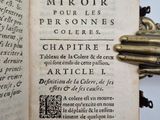 an open book with a key in it on a table