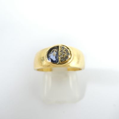 a close up of a gold ring with a blue sapphire stone
