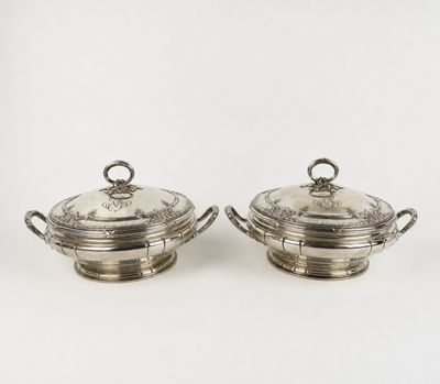 a pair of silverplated dishes with handles and handles