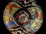 a colorful ball with a design on it on a black background