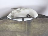 a metal object with a marble top on a table