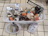 un bac en plastique rempli d'objets divers posé sur un sol carrelé