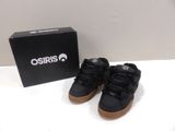 the shoes are on the table next to a box of osiris