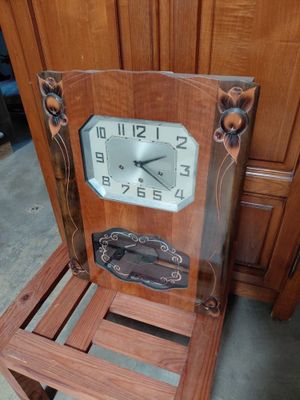 a wooden chair with a clock on the back of it