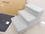 a box of moopz next to a set of stairs