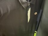 a black shirt with a banana on it hanging on a hanger