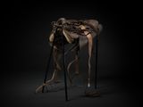 an image of a sculpture of a horse with a saddle on it ' s back