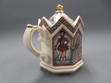 an image of a teapot with a picture of a man on it