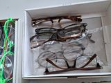 many pairs of glasses in a box on the table