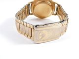 an image of a gold wrist watch with a diamond on the face