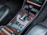 the interior of a car with a wooden dashboard and black leather seats