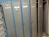many lockers in a room with a lot of wires