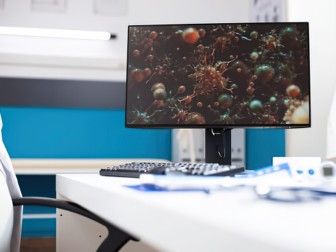 un écran d'ordinateur posé sur un bureau dans un bureau