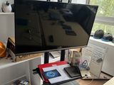 a computer desk with a monitor and a laptop on it