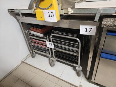 a lot of trays of food on the shelf in the kitchen