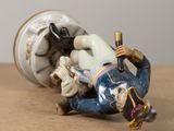 a figurine of a man laying on a table