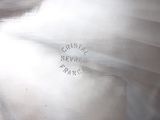 a close up picture of a silver vase with writing on it